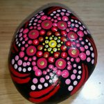 Mandala painting on a smooth river rock